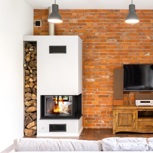 Brick wall living room with modern fireplace, vintage wooden cabinet and tv set
